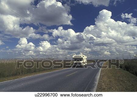 Stock Image -  road, FL, Everglades Nat'l Park, Florida, A Winnebago travels on the road through the Grasslands of Everglades National Park.. Fotosearch