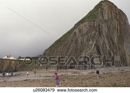 Stock Photo -  Rocher Perce, Gaspe Peninsula, Perce, Quebec, Canada, Gulf of St. Lawrence, People walk out to Perce Rock (Rocher Perce) at low tide on the Gulf of St. Lawrence in Perce on Gaspe Peninsula in Quebec.. Fotosearch