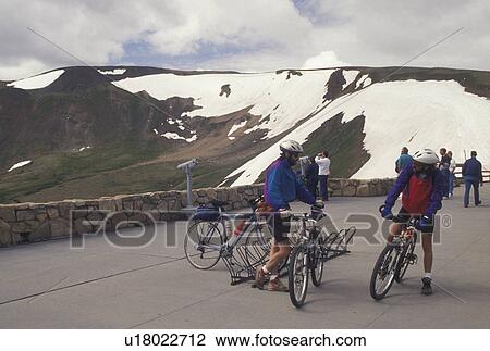 Stock Image -  Rocky Mountain National Park, mountain biking, CO, Colorado, Men on mountains bikes at scenic Fall River Pass overlook at the Alpine Visitor Center along the Scenic Trail Ridge Road in Rocky Mountain Nat'l Park.. Fotosearch
