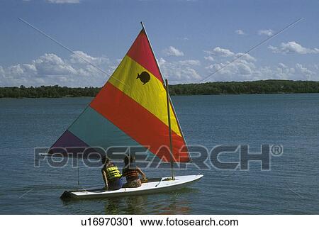 sailing, MN, Minnesota, Alexandria, A couple sails a sunfish on Maple Lake in Alexandria in the summer. View Large Photo Image Stock Image - sailing, MN, Minnesota, Alexandria, A couple sails a sunfish on Maple Lake in Alexandria in the summer.. Fotosearch