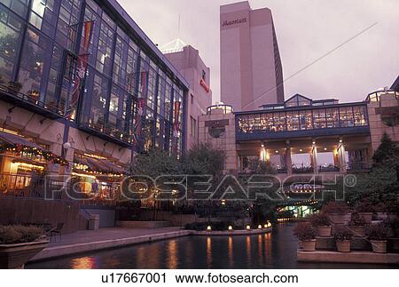 Stock Image -  San Antonio, TX, The Riverwalk, Texas, River Center at Paseo Del Rio, The Riverwalk, in downtown San Antonio in the evening. . Fotosearch