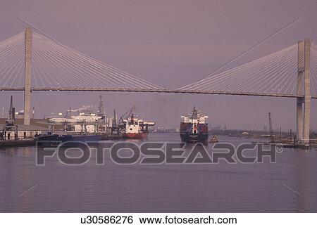Savannah, GA, bridge, Georgia, A cargo ship passes under Talmadge Memorial Bridge which crosses the Savannah River in Savannah. View Large Photo Image Stock Photograph - Savannah, GA, bridge, Georgia, A cargo ship passes under Talmadge Memorial Bridge which crosses the Savannah River in Savannah.. Fotosearch