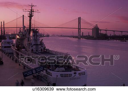 Savannah, GA, Coast Guard, Georgia, The Duntless, U. S. Coast Guard Boat, docked along the Historic River Front on the Savannah River at dusk in Savannah. Talmadge Memorial Bridge crossing the Savannah River in the distance. View Large Photo Image Stock Photo - Savannah, GA, Coast Guard, Georgia, The Duntless, U. S. Coast Guard Boat, docked along the Historic River Front on the Savannah River at dusk in Savannah. Talmadge Memorial Bridge crossing the Savannah River in the distance.. Fotosearch