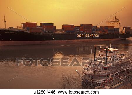Savannah, GA, Georgia, A huge cargo ship carrying containers passes along the Historic River Front on the Savannah River in Savannah. The Savannah River Queen Riverboat is docked along the Historic River Front. View Large Photo Image Stock Photograph - Savannah, GA, Georgia, A huge cargo ship carrying containers passes along the Historic River Front on the Savannah River in Savannah. The Savannah River Queen Riverboat is docked along the Historic River Front.. Fotosearch