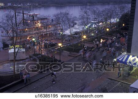 Savannah, GA, Georgia, St. Patrick's Day Celebration in the evening along the Historic River Front in Savannah. The Savannah River Queen Riverboat is reflected in the glass building. View Large Photo Image Stock Photography -  Savannah, GA, Georgia, St. Patrick's Day Celebration in the evening along the Historic River Front in Savannah. The Savannah River Queen Riverboat is reflected in the glass building.. Fotosearch