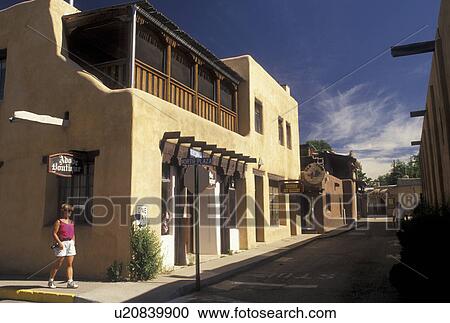 shops, Taos, NM, New Mexico, Woman walking next to adobe style shops in downtown Taos. View Large Photo Image Stock Image - shops, Taos, NM, New Mexico, Woman walking next to adobe style shops in downtown Taos.. Fotosearch