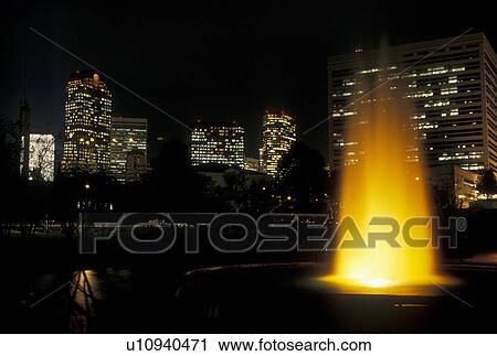 Stock Image -  skyline, Charlotte, NC, North Carolina, Downtown skyline of Charlotte from the fountain at Marshall Park at night.. Fotosearch