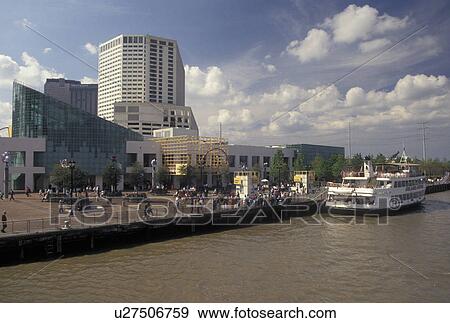 Stock Photo -  skyline, New Orleans, Louisiana, LA, View of the Aquarium of the Americas and downtown skyline of New Orleans along the Mississippi River. Passenger ferry along the riverfront.. Fotosearch