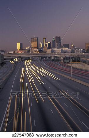 skyline, road, traffic, Atlanta, GA, Georgia, Traffic lights streak on I-75/I-85 at sunset and view of the skyline of downtown Atlanta. View Large Photo Image Stock Photo - skyline, road, traffic, Atlanta, GA, Georgia, Traffic lights streak on I-75/I-85 at sunset and view of the skyline of downtown Atlanta.. Fotosearch
