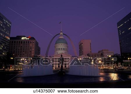 Stock Photo -  St. Louis, MO, Missouri, View of the Old Courthouse and Gateway Arch from fountain at Kiener Plaza in downtown Saint Louis in the evening. Jefferson National Expansion Memorial.. Fotosearch