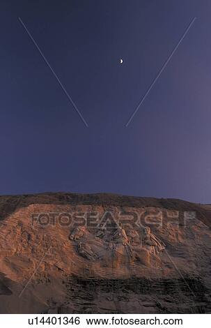 Stock Photograph -  Stone Mountain, moon, GA, Atlanta, Confederate Memorial Carving, Georgia, Moonrise over The Confederate Memorial Carving on Stone Mountain a massive dome of granite rock at Georgia's Stone Mountain Park in Atlanta. . Fotosearch