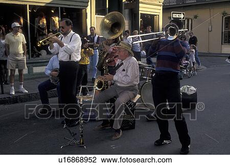Stock Image -  street musicians, jazz, French Quarter, New Orleans, LA, Louisiana, Street musicians entertain a crowd of people along the street in the French Quarter in New Orleans. . Fotosearch