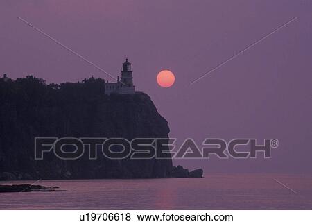 sunrise, lighthouse, Lake Superior, North Shore Drive, Two Harbors, MN, Minnesota, A red sun rises behind Split Rock Lighthouse which is situated on a high cliff on the north shore of Lake Superior at Split Rock Lighthouse State Park in Two Harbors. View Large Photo Image Stock Photo - sunrise, lighthouse, Lake Superior, North Shore Drive, Two Harbors, MN, Minnesota, A red sun rises behind Split Rock Lighthouse which is situated on a high cliff on the north shore of Lake Superior at Split Rock Lighthouse State Park in Two Harbors.. Fotosearch