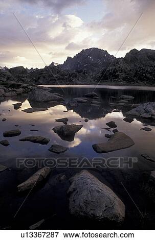 sunset, lake, Wind River Range, Bridger-Teton National Forest, WY, Wyoming, Reflection of the rocks and surrounding mountains in the calm waters of Island Lake at sunset in the Wind River Range Mountains in the Bridger-Teton Nat'l Forest in Wyoming. View Large Photo Image Stock Photo - sunset, lake, Wind River Range, Bridger-Teton National Forest, WY, Wyoming, Reflection of the rocks and surrounding mountains in the calm waters of Island Lake at sunset in the Wind River Range Mountains in the Bridger-Teton Nat'l Forest in Wyoming.. Fotosearch