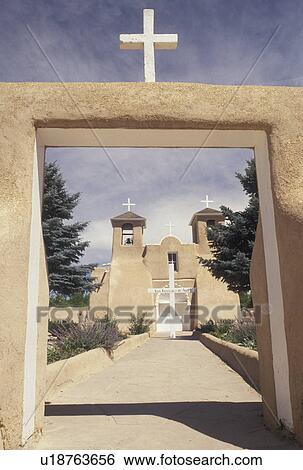 Taos, church, NM, New Mexico, a cross over the entrance to San Francisco De Asis a mission church in Taos. Franciscan Old World architecture. View Large Photo Image Stock Photograph - Taos, church, NM, New Mexico, a cross over the entrance to San Francisco De Asis a mission church in Taos. Franciscan Old World architecture.. Fotosearch