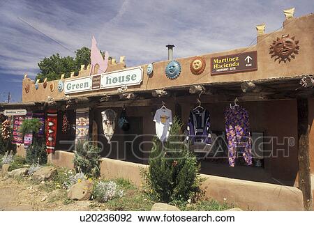 Taos, NM, New Mexico, Colorful clothes and rugs hanging from the porch of a florist shop in Taos. View Large Photo Image Stock Image - Taos, NM, New Mexico, Colorful clothes and rugs hanging from the porch of a florist shop in Taos.. Fotosearch