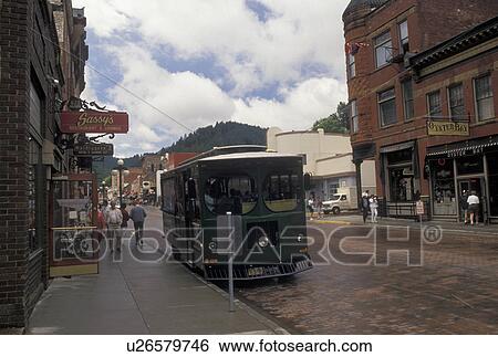 trolley, Deadwood, SD, South Dakota, Black Hills, Deadwood Trolley stop on Main Street in downtown Deadwood a National Historic Landmark. View Large Photo Image Stock Photograph -  trolley, Deadwood, SD, South Dakota, Black Hills, Deadwood Trolley stop on Main Street in downtown Deadwood a National Historic Landmark.. Fotosearch