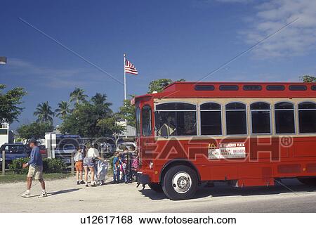 trolley, Fort Myers, FL, Gulf of Mexico, Florida, Red trolley bus picks up passengers along the beach front in Fort Myers. View Large Photo Image Stock Photo - trolley, Fort Myers, FL, Gulf of Mexico, Florida, Red trolley bus picks up passengers along the beach front in Fort Myers.. Fotosearch