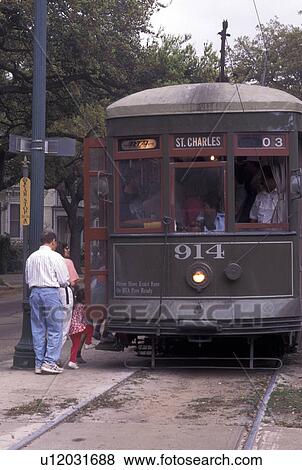 trolley, New Orleans, LA, Louisiana, St. Charles Avenue Streetcar picks up passengers along Saint Charles Street in New Orleans. View Large Photo Image Stock Photo - trolley, New Orleans, LA, Louisiana, St. Charles Avenue Streetcar picks up passengers along Saint Charles Street in New Orleans.. Fotosearch
