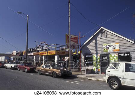 Stock Photo -  Tybee Island, GA, Georgia, Cafes, bars and shops along the street on Tybee Island in Georgia. Fotosearch