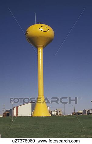 Stock Image -  water tower, Adair, NE, Nebraska, Yellow water tower with smiley face in Adair.. Fotosearch