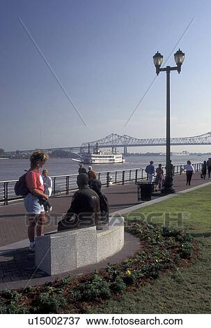 waterfront, New Orleans, Mississippi River, Riverfront Park, LA, Louisiana, Woman looking at a statue as people walk by on the Moonwalk at Waldenberg Riverfront Park along the Mississippi River in New Orleans. Steamboat cruises in the distance on the Mis View Large Photo Image Stock Photo - waterfront, New Orleans, Mississippi River, Riverfront Park, LA, Louisiana, Woman looking at a statue as people walk by on the Moonwalk at Waldenberg Riverfront Park along the Mississippi River in New Orleans. Steamboat cruises in the distance on the Mis. Fotosearch