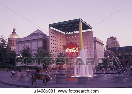 Stock Image -  World of Coca-Cola, Atlanta, GA, Georgia, Fountain outside of World of Coca-Cola in the evening in downtown Atlanta. . Fotosearch