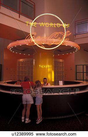 Stock Photography -  World of Coca-Cola, Atlanta, GA, Georgia, Mother and eight year old daughter purchasing tickets at the ticket counter at the World of Coca-Cola in downtown Atlanta. . Fotosearch