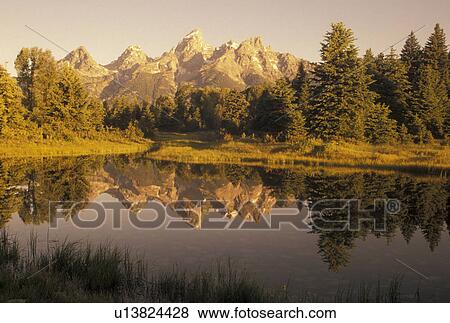 WY, Snake River, sunrise, Grand Teton National Park, Jackson Hole, Wyoming, Scenic view of the Grand Teton Mountains reflecting in the calm waters of the Snake River at sunrise in Grand Teton Nat'l Park in Wyoming. View Large Photo Image Stock Photo - WY, Snake River, sunrise, Grand Teton National Park, Jackson Hole, Wyoming, Scenic view of the Grand Teton Mountains reflecting in the calm waters of the Snake River at sunrise in Grand Teton Nat'l Park in Wyoming.. Fotosearch