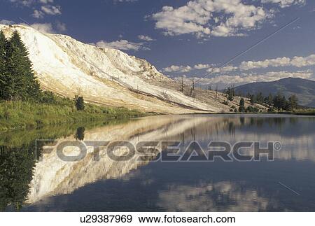 Stock Photo -  Yellowstone National Park, Mammoth Hot Springs, WY, Wyoming, Canary Springs reflect in the calm waters of a pond at Mammoth Hot Springs in Yellowstone Nat'l Park in Wyoming. . Fotosearch