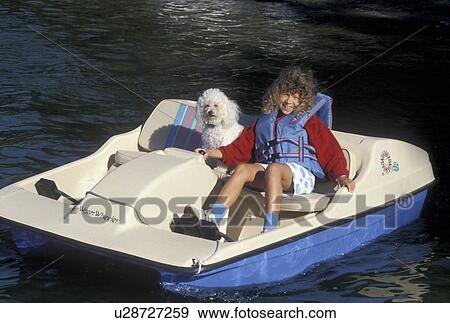 young girl, dog, boating, MN, Minnesota, Alexandria, Eight year old girl with her pet dog paddling on Maple Lake with a paddle boat in Alexandria. View Large Photo Image Stock Photo - young girl, dog, boating, MN, Minnesota, Alexandria, Eight year old girl with her pet dog paddling on Maple Lake with a paddle boat in Alexandria.. Fotosearch
