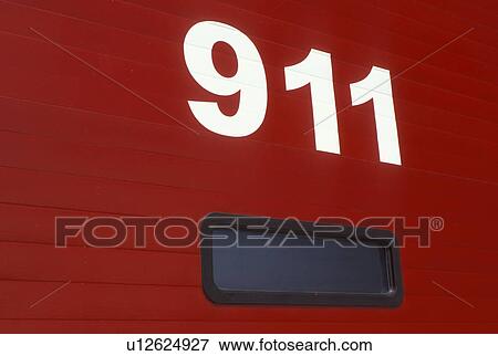Stock Photo - 911, Thunder Bay, Canada, Ontario, 911 on the red door of a firestation. . Fotosearch