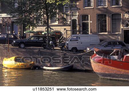 Amsterdam, Holland, Netherlands, Noord-Holland, Europe, Boat shaped like a wooden shoe docked along a canal in Amsterdam. View Large Photo Image Stock Image - Amsterdam, Holland, Netherlands, Noord-Holland, Europe, Boat shaped like a wooden shoe docked along a canal in Amsterdam.. Fotosearch