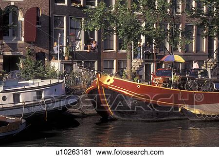 Amsterdam, Netherlands, Holland, Noord-Holland, Europe, Houseboats docked along a canal in Amsterdam. View Large Photo Image Stock Image - Amsterdam, Netherlands, Holland, Noord-Holland, Europe, Houseboats docked along a canal in Amsterdam.. Fotosearch