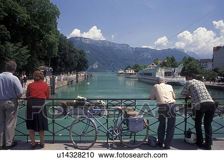 Annecy, France, Haute-Savoie, Rhone-Alpes, Europe, People looking at scenic Thiou canal and Lake Annecy (Lac d' Annecy) from bridge on the waterfront in Annecy. View Large Photo Image Stock Image - Annecy, France, Haute-Savoie, Rhone-Alpes, Europe, People looking at scenic Thiou canal and Lake Annecy (Lac d' Annecy) from bridge on the waterfront in Annecy.. Fotosearch