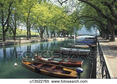 Annecy, France, Haute-Savoie, Rhone-Alpes, Europe, Wooden rowboats docked along the tree-lined Vasse canal on scenic Lake Annecy (Lac d' Annecy) in Annecy. View Large Photo Image Stock Photography - Annecy, France, Haute-Savoie, Rhone-Alpes, Europe, Wooden rowboats docked along the tree-lined Vasse canal on scenic Lake Annecy (Lac d' Annecy) in Annecy. . Fotosearch