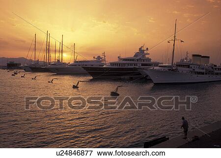 Antibes, Cote d' Azur, France, Provence, Alpes-Maritimes, Europe, Yachts docked in Port Vauban Harbor on the Mediterranean Sea in the city of Antibes at sunset. View Large Photo Image Stock Photo - Antibes, Cote d' Azur, France, Provence, Alpes-Maritimes, Europe, Yachts docked in Port Vauban Harbor on the Mediterranean Sea in the city of Antibes at sunset. . Fotosearch