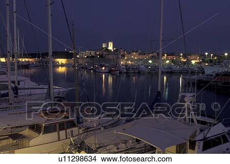 Antibes, Cote d' Azur, Provence, France, Alpes-Maritimes, Europe, Boats docked in Port Vauban Harbor on the Mediterranean Sea in the city of Antibes in the evening. View Large Photo Image Picture - Antibes, Cote d' Azur, Provence, France, Alpes-Maritimes, Europe, Boats docked in Port Vauban Harbor on the Mediterranean Sea in the city of Antibes in the evening.. Fotosearch