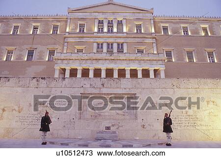 Athens, Greece, Parliament, Europe, Guards of Honor (evzones) standing at the Tomb of the Unknown Soldier at the House of the Greek Parliament at Plateia Syntagmatos (Constitution Square) in the evening in downtown Athens. View Large Photo Image Stock Image - Athens, Greece, Parliament, Europe, Guards of Honor (evzones) standing at the Tomb of the Unknown Soldier at the House of the Greek Parliament at Plateia Syntagmatos (Constitution Square) in the evening in downtown Athens.. Fotosearch