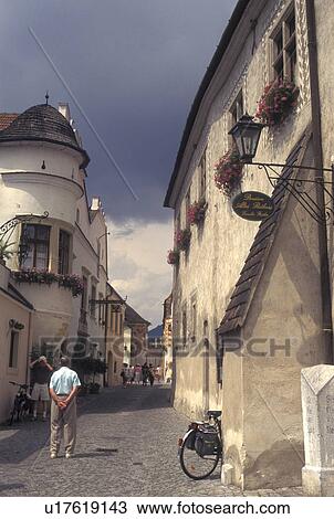 Stock Image -  Austria, Durnstein, The Danube Valley, Wachau, Narrow cobblestone pedestrian street in the village of Durnstein. Fotosearch