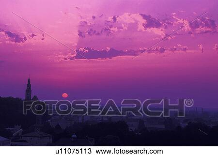 Stock Image -  Austria, Salzburg, View of the city of Salzburg at sunset . Fotosearch