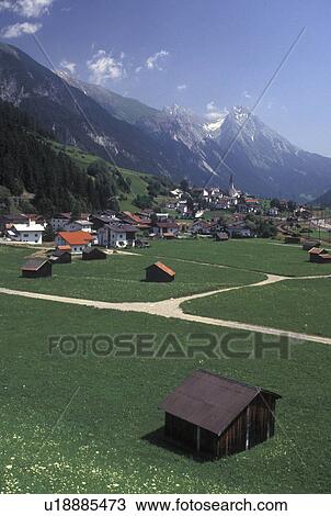 Stock Image -  Austria, Tirol, Strengen, Picturesque view of the scenic village of Strengen and the Austrian Alps.. Fotosearch