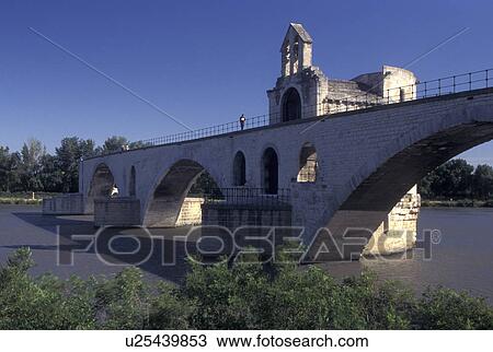 Stock Image -  Avignon, France, Provence, Vaucluse, Europe, 12th century Pont St-Benezet on the Rhone River in Avignon. A popular old children's song was named after the bridge 'sur le pont d'Avignon'.. Fotosearch