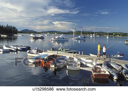 Bass Harbor, ME, Maine, Mount Desert Island, Boys fishing off the dock with view of boats in the harbor in the fishing village of Bass Harbor on the Atlantic Ocean. View Large Photo Image Stock Photograph - Bass Harbor, ME, Maine, Mount Desert Island, Boys fishing off the dock with view of boats in the harbor in the fishing village of Bass Harbor on the Atlantic Ocean.. Fotosearch