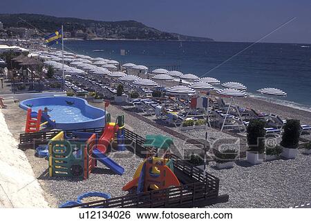 beach, France, Nice, Cote d' Azur, Provence, Alpes-Maritimes, Europe, A view of the beach along the Mediterranean Sea in the city of Nice. View Large Photo Image Stock Photograph - beach, France, Nice, Cote d' Azur, Provence, Alpes-Maritimes, Europe, A view of the beach along the Mediterranean Sea in the city of Nice.. Fotosearch