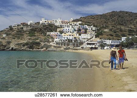 beach, Ios, Greek Islands, Cyclades, Greece, Europe, Couple walks along Milopotas Beach on Ios Island on the Aegean Sea. View Large Photo Image Stock Image - beach, Ios, Greek Islands, Cyclades, Greece, Europe, Couple walks along Milopotas Beach on Ios Island on the Aegean Sea.. Fotosearch