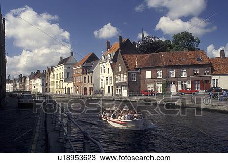 Belguim, Brugge, Bruges, West-Vlaanderen, Europe, A cruise boat takes passengers along the canal in Bruges. View Large Photo Image Stock Image - Belguim, Brugge, Bruges, West-Vlaanderen, Europe, A cruise boat takes passengers along the canal in Bruges.. Fotosearch