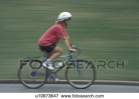 Stock Photo -  biking, Atlanta, GA, Georgia, Panning of a woman biking in Piedmont Park in Atlanta.. Fotosearch