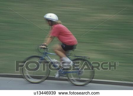 Stock Photo -  biking, Atlanta, GA, Georgia, Panning of a woman biking in Piedmont Park in Atlanta.. Fotosearch