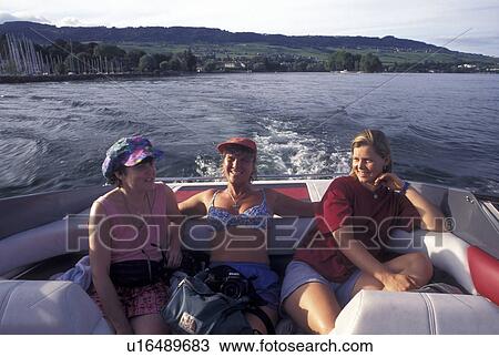 boating, Switzerland, Lac Leman, Vaud, Rolle, La Cote, Three women enjoying a boat ride on Lake Geneva in the summer. View Large Photo Image Stock Image - boating, Switzerland, Lac Leman, Vaud, Rolle, La Cote, Three women enjoying a boat ride on Lake Geneva in the summer.. Fotosearch